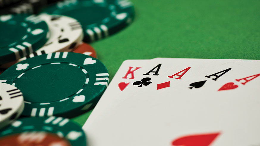 Playing Cars of King and four Aces on a green table with poker chips