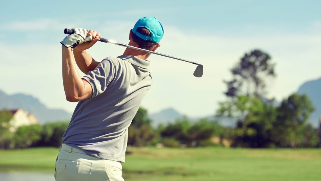 Golfer Swinging golf club.