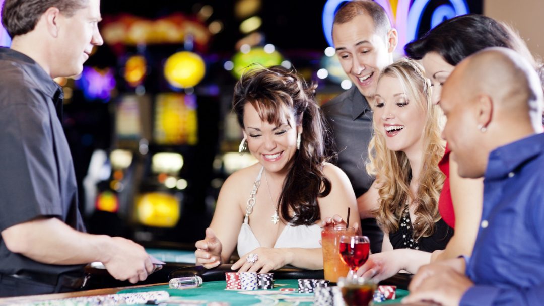 a photo of friends gambling at the table