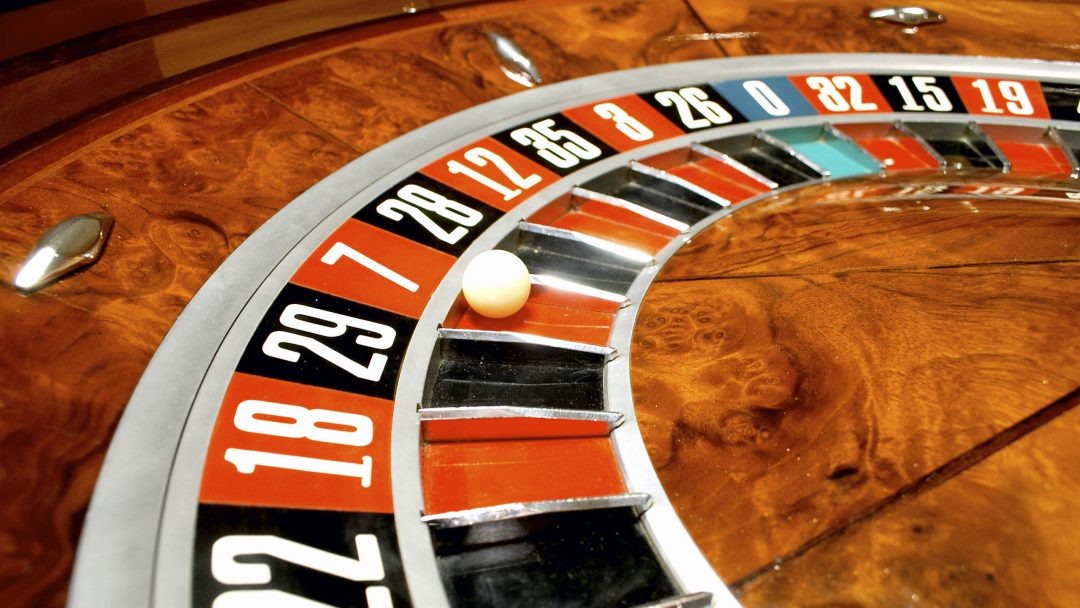 Roulette wheel with white ball on number seven